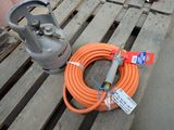 an orange hose and a propanene on a pallet