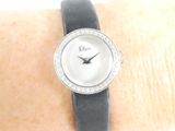 a woman ' s wrist that has a watch on it