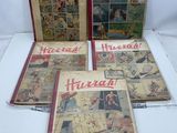 quatre bandes dessinées anciennes exposées sur une table