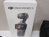 a box with a camera attached to it next to a pair of shoes and a bag