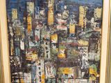 an oil painting of a cityscape in a gold frame