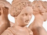 three statues of a woman holding a baby in her arms