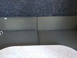 a couch and a table in a room with a wallpapered wall