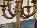 a gold chandelier hanging from a ceiling in a room
