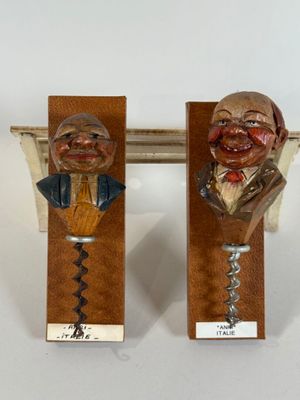 two wine openers with a man and a woman on them
