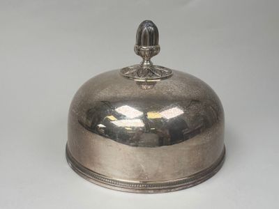 a silver plate with a bell on top of it