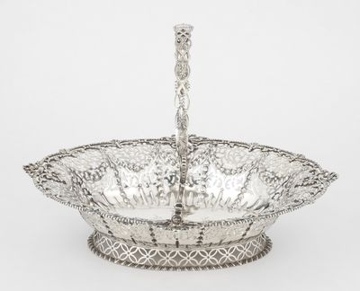 a silver plated bowl with a handle on a stand