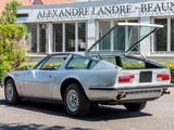 a silver sports car parked in front of a building