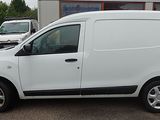 a small white van parked in front of a building