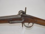 a close up of a rifle on display on a wall