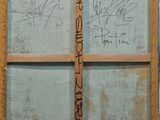a wooden door with writing on it in a room