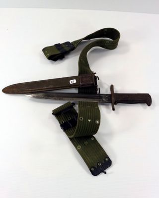 a knife and a belt on a white surface