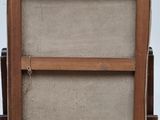 an old wooden easel sitting on top of a wooden table