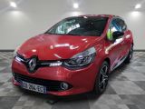 a red car is parked in a garage with a checkered floor
