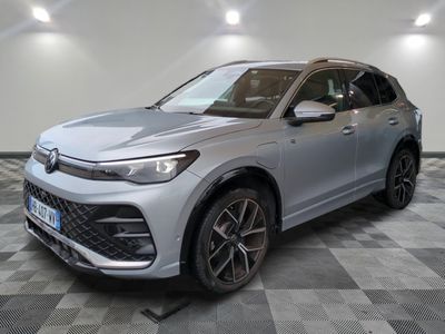 a silver suv parked on a checkered floor in a garage