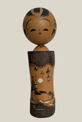 a wooden doll with a black and white design on it ' s head