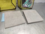 two pieces of paper sitting on a table next to a yellow bag