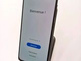 a close up of a cell phone on a stand on a white surface