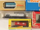 several boxes of toy trains sitting on top of a white surface