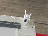 a camera attached to the side of a building