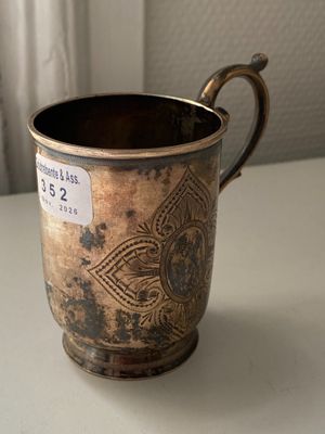 a cup that is sitting on a table with a tag on it