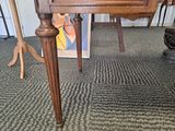 a table with a clock on top of it in a room