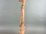 an image of a wooden sculpture of a hammer on a black base