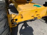 a large yellow tractor that is parked on the street