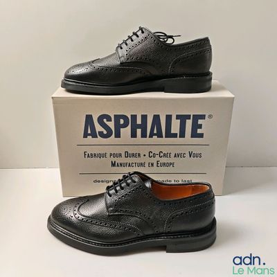 men ' s black leather shoes with laces on top of a box