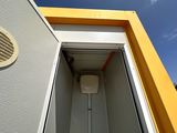 a toilet that is in a yellow and white building