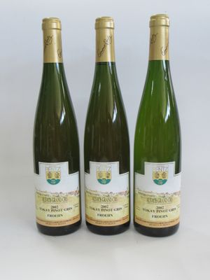 three bottles of wine sitting on a table next to each other