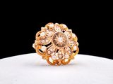 a close up of a gold ring on a white surface