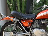 an orange motorcycle parked on the side of the street
