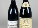 two bottles of red wine sitting next to each other on a table