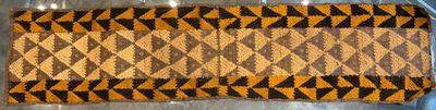 a brown and black rug on a table in a room
