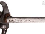 a close up of a metal object with a hammer on it