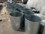several metal buckets are lined up in front of a building