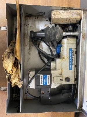 a box that has a drill and other tools inside of it