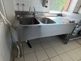 a kitchen with a stainless steel sink and a large window