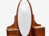 a wooden dressing table with a mirror on top of it