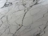 a close up of a marble counter top with a sink