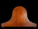 a wooden clock that is sitting on a black background