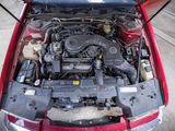 a red car with its hood open and the engine in it