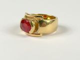 an image of a gold ring with a red stone