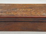 a wooden box with a name on it sitting on a table