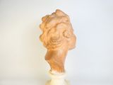 a sculpture of a woman ' s head on a pedestal