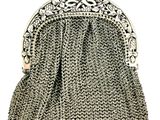 a silver metal purse with a chain handle
