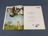 an open book with a picture of a boat on the water