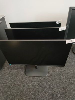 a computer monitor sitting on top of a desk