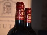 two bottles of wine sitting next to each other on a table